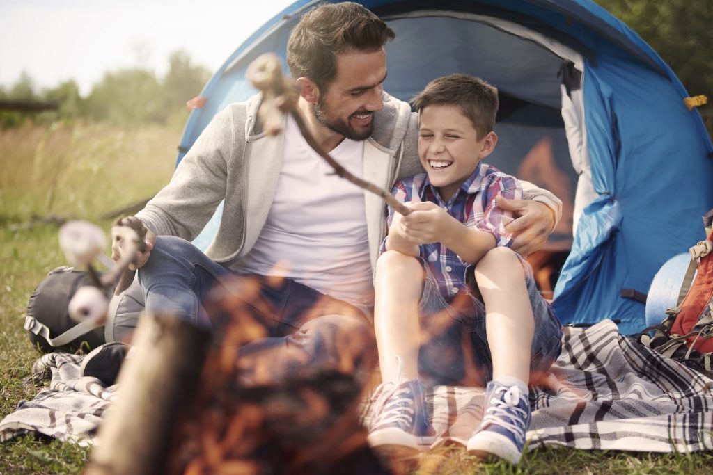 pai e filho se divertindo no camping