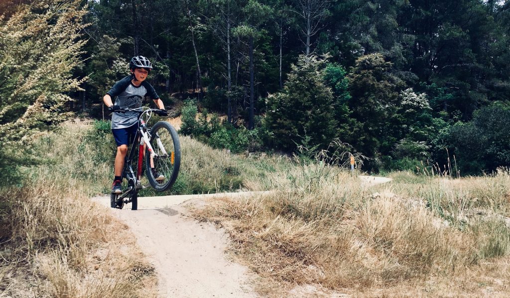 Jovem se aventurando no Mountain Bike Freeride