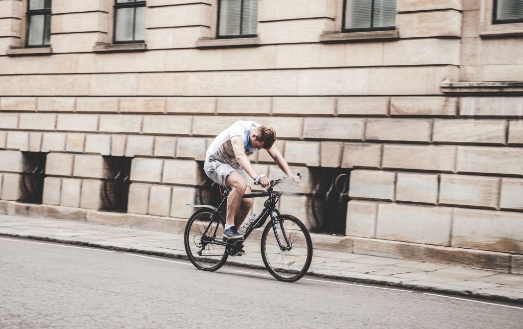 ciclista cansado pedalando na rua